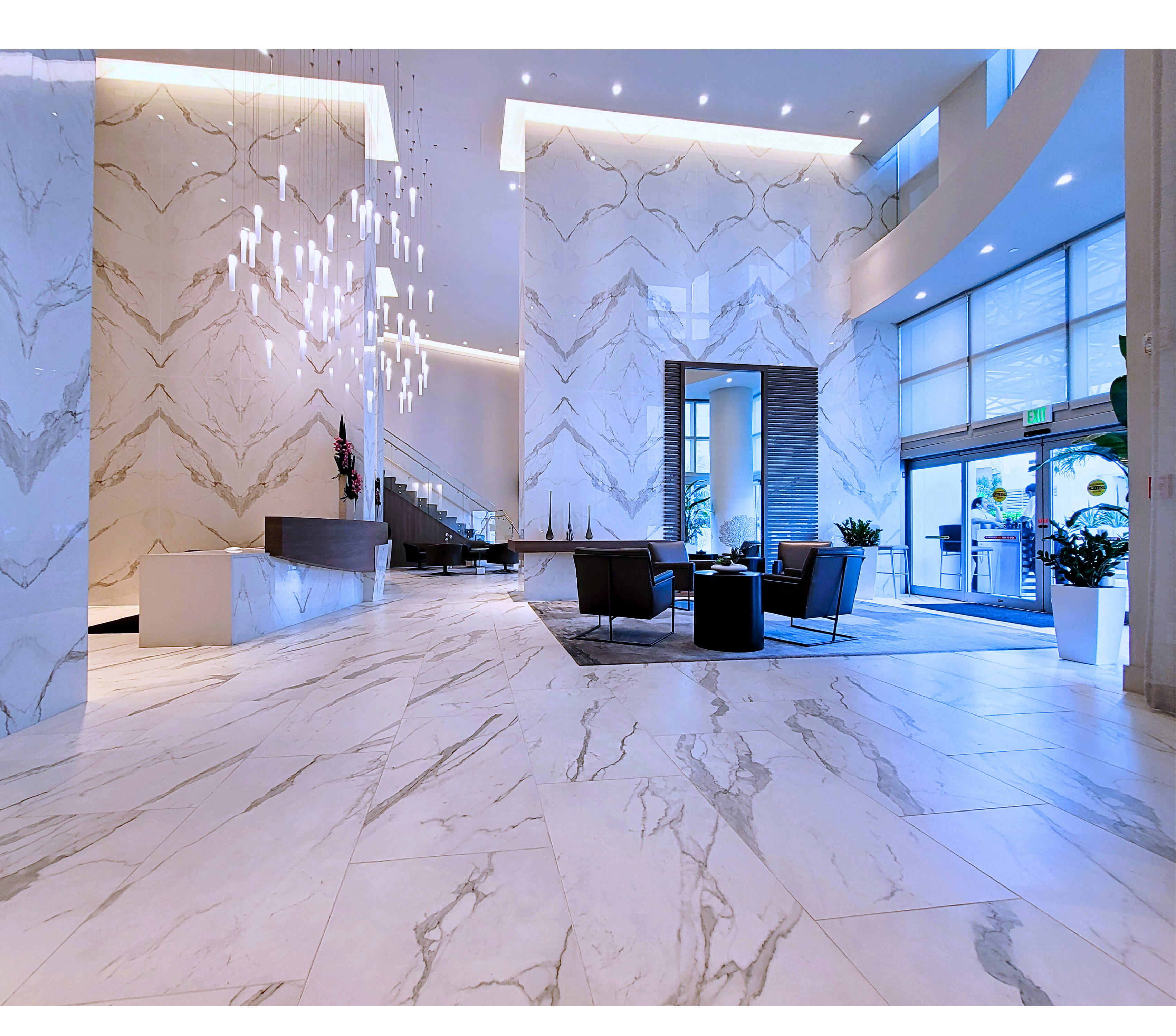 Bookmatched Laminam Calacatta porcelain slab cladding in a Brickell residence lobby