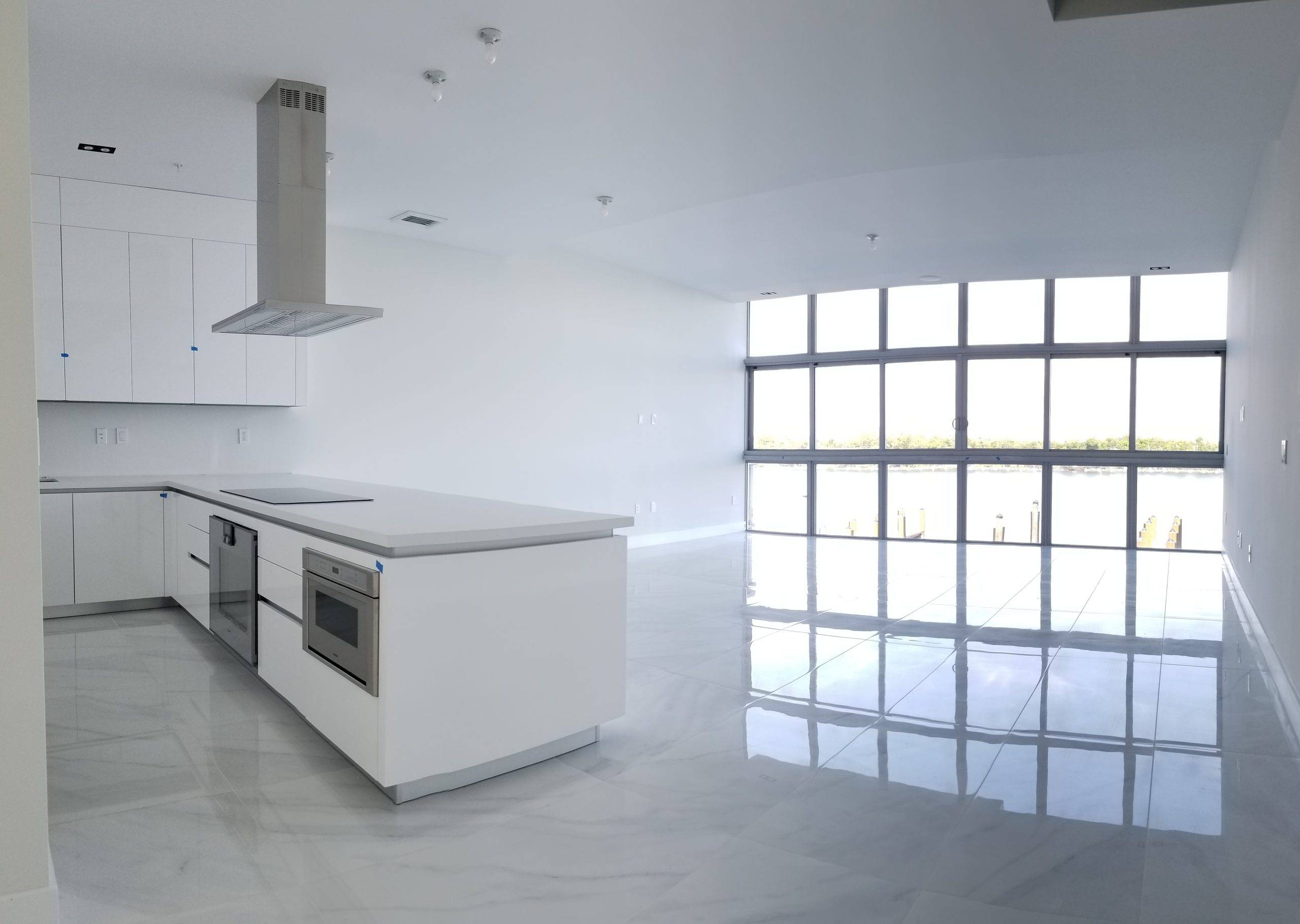 Two-slab Laminam Calacatta floor running across a 12,000 sq ft Brickell great room