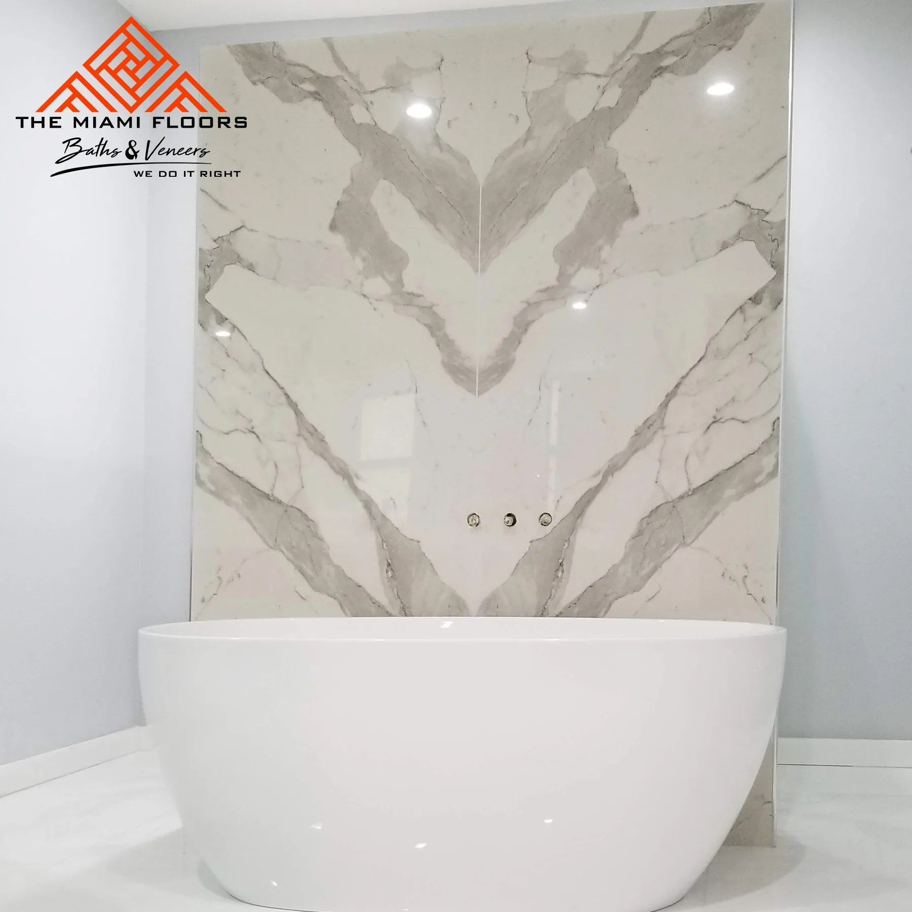 Bookmatched Calacatta slab seam in a Brickell installation, white-grey veining